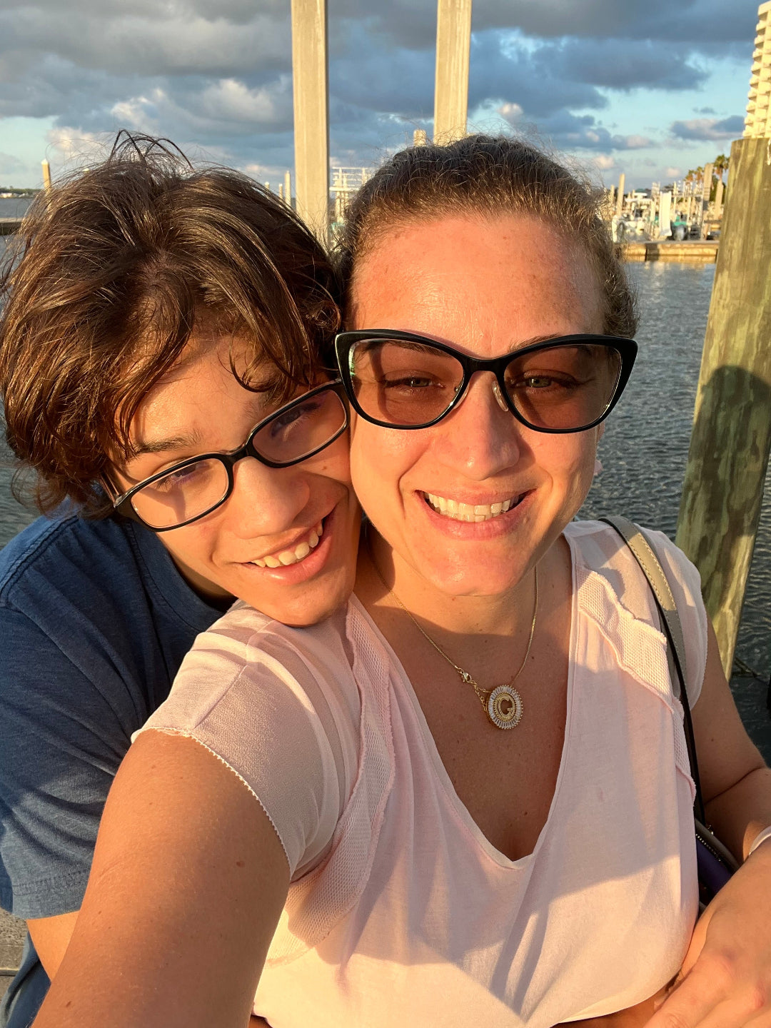 Mother and son smiling outdoors.